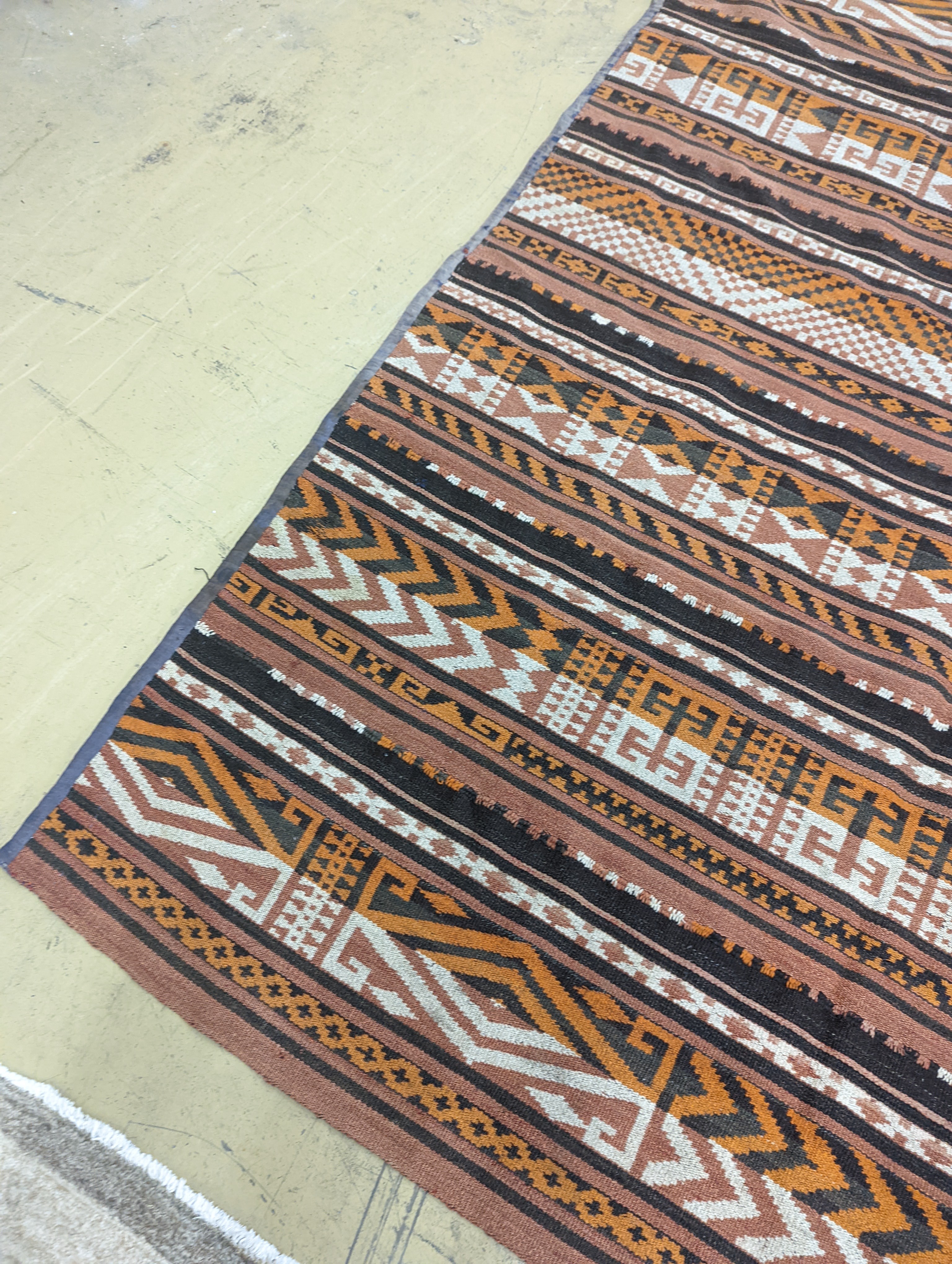 A polychrome flatweave carpet, approx. 330 x 180cm